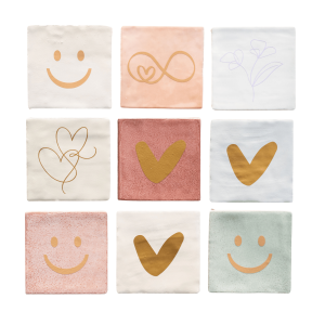 Lottea tegeltjes in verschillende kleuren zoals wit, lichtblauw, groen en roze met verschillende plaatjes erop zoals een gouden hart, een paarse bloem, een gouden smiley gezicht.